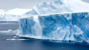 Momentul incredibil în care un iceberg gigantic se rupe și se răstoarnă în apropierea unor turiști