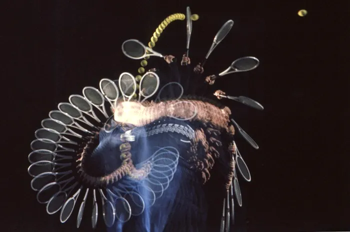 Tennis coach and commentator Vic Braden demonstrates continuous service motion in a single photograph, 1977.